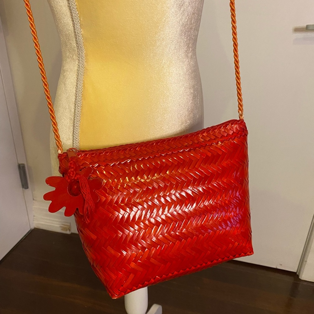 Red straw purse with wooden flower detail